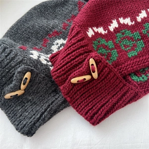 Macro view of knitted winter hats with geometric jacquard patterns and wood toggle buttons