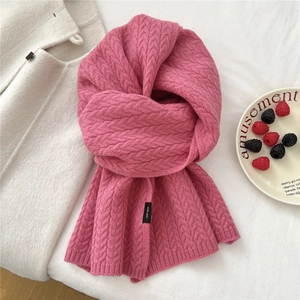 Macro detail of pink chunky cable knit wool scarf with 100% wool material texture