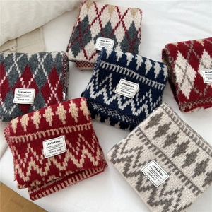 Close-up of geometric diamond pattern and soft knitted texture on thick winter scarves