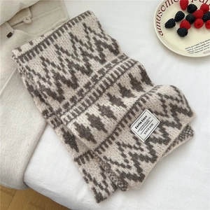 Close-up of geometric knit scarf texture with vintage beige and brown diamond pattern