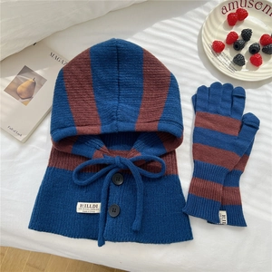Detail of striped knitted balaclava set and gloves in navy blue and brown colors