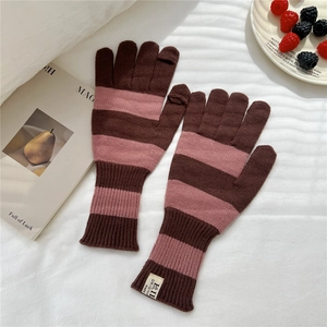 Detail of pink and brown striped knit gloves with touchscreen tips and ribbed cuffs