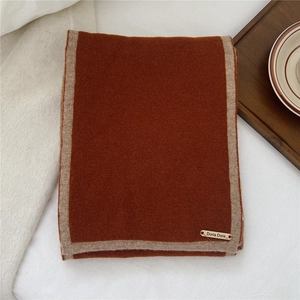Detail of wool scarf showing the vintage caramel color and contrast beige border texture