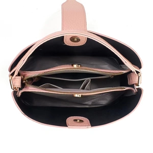 Top view of pink pebbled leather bucket bag interior with compartments and gold magnetic buckle