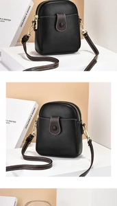 Détail du sac bandoulière en cuir noir avec double fermeture éclair et accessoires dorés