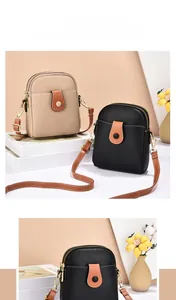 Dual mini crossbody phone bags in apricot and black lychee texture with golden zippers