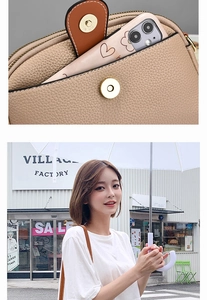 Detail of khaki pebbled leather crossbody bag with dual compartments and magnetic flap