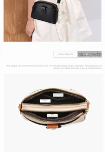Detail view of double-zipper crossbody bag with multi-layer interior and litchi texture