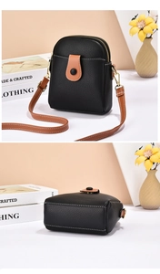Detail of black lychee grain mini crossbody bag with contrast stitching and dual zippers