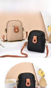 Detailed view of lychee pattern leather mobile phone crossbody bag with double zippers