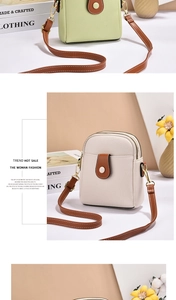 Detail view of lychee pattern leather shoulder bag with dual zippers and brown strap