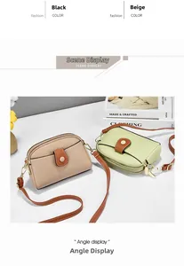 Macro detail of lychee textured PU leather crossbody bag with dual zippers and gold hardware
