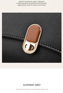 Detailed macro view of golden twist lock hardware on black litchi grain leather handbag