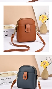 Detail of small crossbody phone bags in brown and blue with contrast stitching and gold hardware