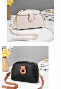 Detail view of small shell-shaped crossbody bags in beige and black-orange textured leather