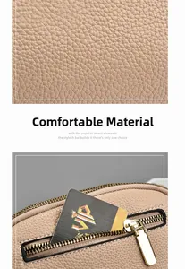Detailed macro view of beige pebble grain leather texture and gold-tone metal zipper