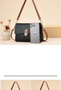 Size comparison of black litchi pattern mini crossbody bag with a mobile phone