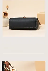 Close-up of litchi leather texture with white stitching and gold hardware on a black bag