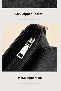 Close-up of black lychee grain leather bag with gold zipper and back pocket detail