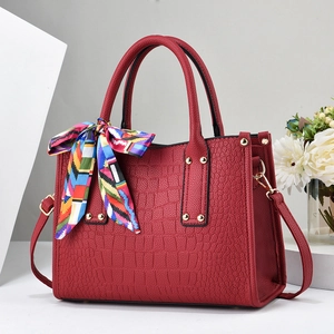 Red crocodile embossed leather handbag with silk scarf handle and gold hardware