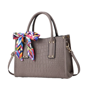 Women's faux crocodile leather handbag in khaki with dual handles and decorative silk scarf