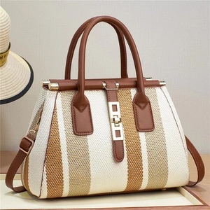 Large capacity striped woven handbag with brown leather straps and gold metal clasp
