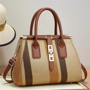 Classic striped woven handbag with brown leather handle and gold twist lock in summer style