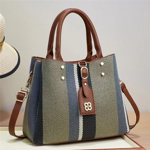 Contrast striped woven tote bag with brown faux leather handles and shoulder strap