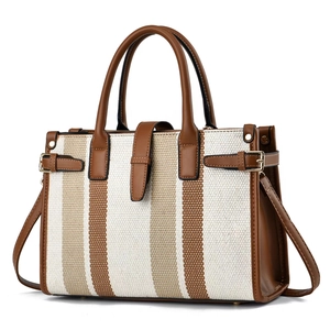 Elegant striped canvas tote bag with brown faux leather trim and top handles in white background