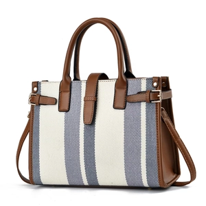 Blue and white striped canvas tote bag with brown leather handles and gold buckles