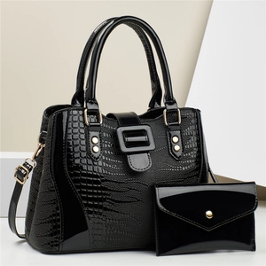 Glossy black crocodile-embossed tote bag set with matching clutch and gold-toned hardware