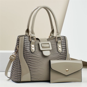 Elegant grey crocodile embossed handbag set with matching envelope wallet and gold hardware