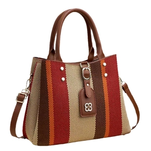 Chic multi-color striped woven handbag with brown leather handles and silver clover charm