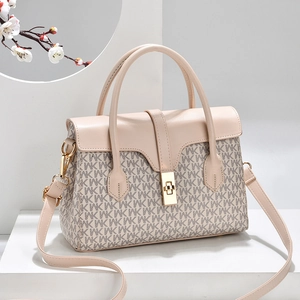 Beige monogram top handle bag with gold twist lock on geometric minimalist display