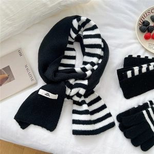 Classic black and white striped knit scarf and gloves set for winter warmth