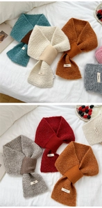 Detail of colorful knitted loop yarn scarves arranged with lifestyle decor props