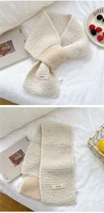 Close-up of cream chunky knit scarf with ribbed cuff and soft texture for winter warmth
