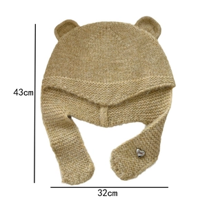 Détail de la capuche en tricot ours avec boucle cœur et dimensions de 43x32cm