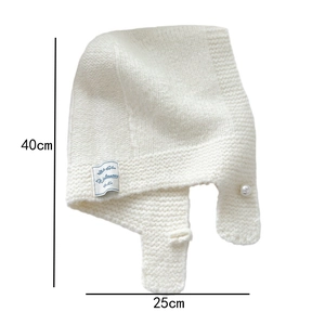 Detail showing knit scarf hood dimensions 40x25cm with pearl buckle and winterwear label