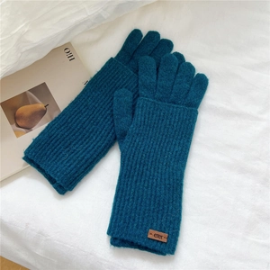 Close-up of peacock blue ribbed knit gloves with double-layer warmth and leather patch