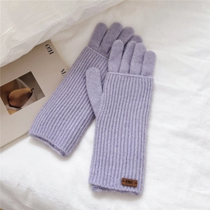 Detailed close-up of light purple knitted winter gloves with cozy ribbed wrist cuffs