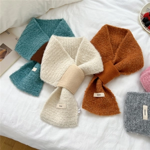 Chic knitted cross scarf set in warm contrasting colors with soft textured boucle yarn