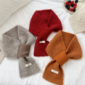 Solid color knitted cross scarf in grey, red, and yellow with warm fleece texture