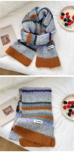 Close-up of colorful striped knit scarf with fluffy mohair texture and brand label