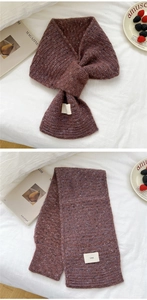 Detail of red-brown knit scarf showing marled texture and ins brand label detail