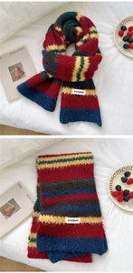 Close-up of colorful striped knit scarf with soft mohair texture and logo detail