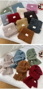 Close-up of soft knitted scarf textures in multiple colors and the Bonogreed brand label