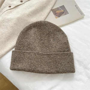 Close-up of coffee brown marled knit beanie with colorful fiber specks and ribbed texture