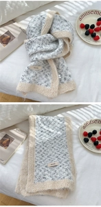 Detail showing two-tone knit scarf with BONOGEED brand tag and soft plush texture