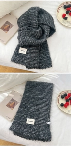 Detail of dark grey knit scarf with fuzzy mohair texture and Bonogeed brand label